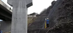 Leica laser tripod surveying a bridge.