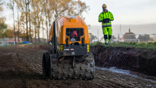 Ammann remote control trench roller. Operator operates safely out of the trench.