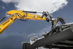 Liebherr sorting grapple tearing up a roof.