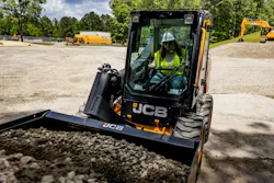 JCB skid steer picking up gravel.