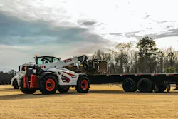 Bobcat TL923 telehandler picking up pallets off a trailer.