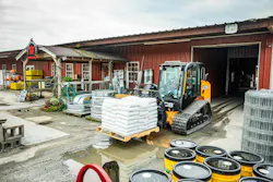 JCB 270 track loader moving a pallet for fertilizer.
