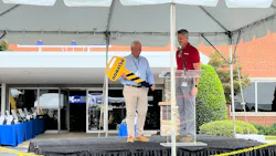 Ceremonial key presentation on a stage