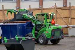 Avant Tecno USA e727 small articulated loader dumping into a bin.