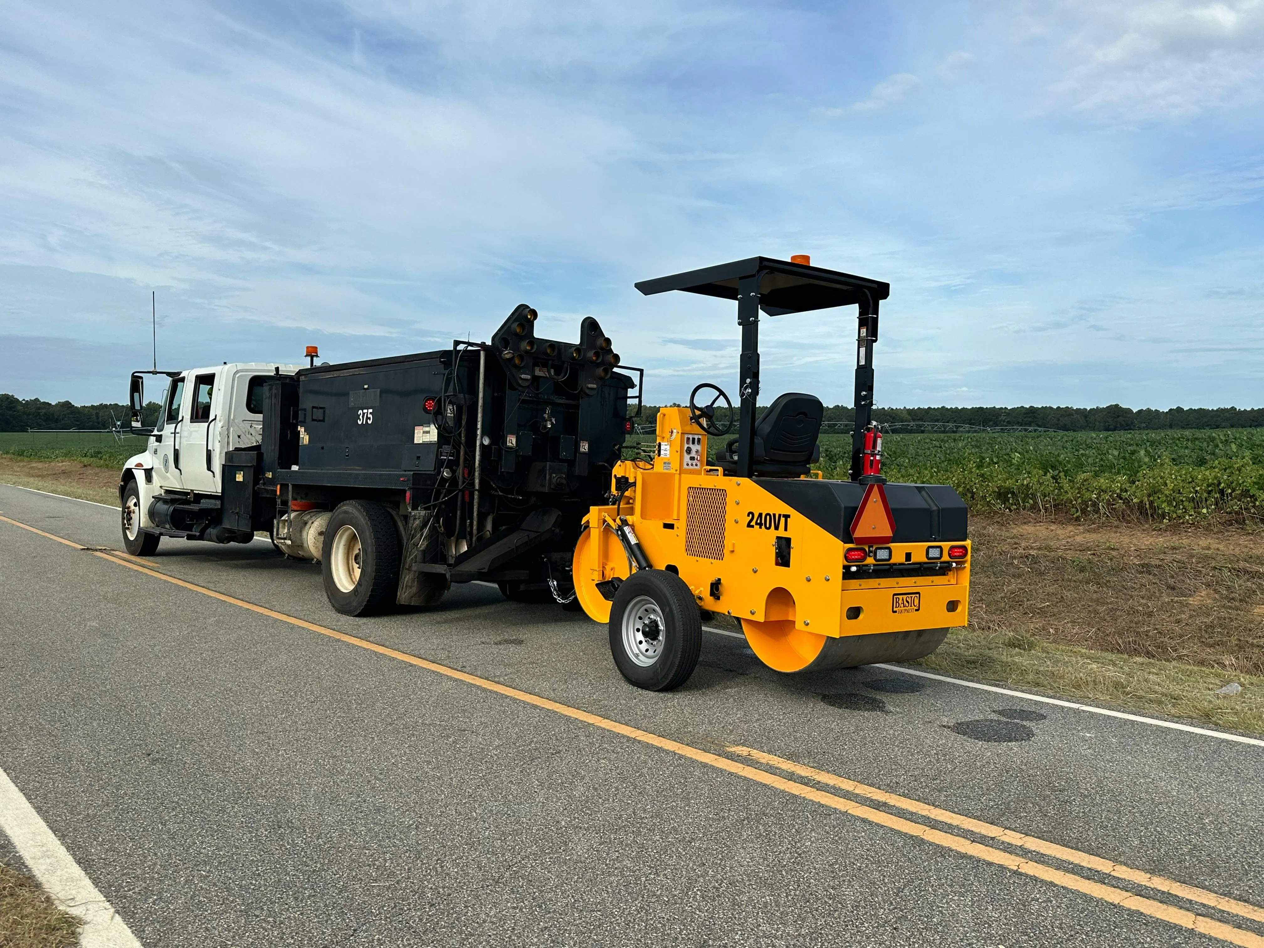 Basic Model 240VT towable split drum roller being towed behind a truck.