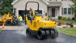 Sakai TS160-4 pneumatic tire roller compacting a driveway.