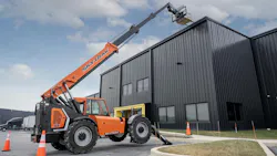 JLG SkyTrak 12054 telehandler lifting pallets to a roof.
