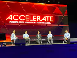 Hitachi dealer meeting panel on stage with Accelerate in the background.