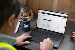 Bobcat Machine IQ. Contractor working on a laptop.