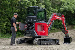 Yanmar SmartAssist telematics platform. Man opens up the engine bay of a Yanmar mini excavator.