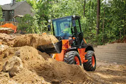 Hitachi zw80u5b compact wheel loader lifting dirt from a pile.