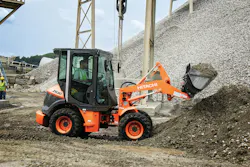 Hitachi ZW30-5B compact wheel loader digging into an aggregate pile.