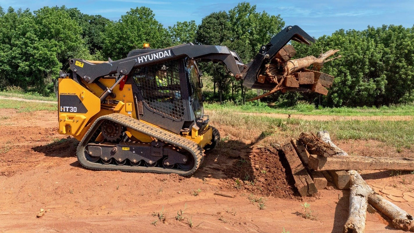 With a frame size suited for a variety of landscaping, residential contracting, municipal and residential applications, the Hyundai HT30 compact track loader is available from the factory in any of three versions: cab with high-flow, cab with standard flow, and canopy with standard flow.