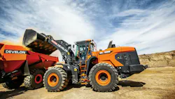 Big Develon wheel loader dumping into an ADT.