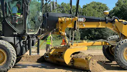 Grader pushing dirt