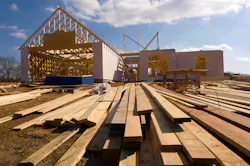 New house under construction. New home under construction with wood, trusses and supplies