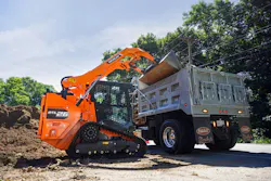 Develon DTL26 compact track loader loading a dump truck.