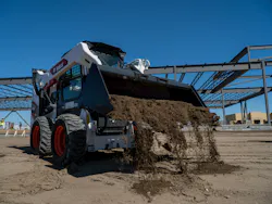 Ignite Attachments bucket dumping dirt.