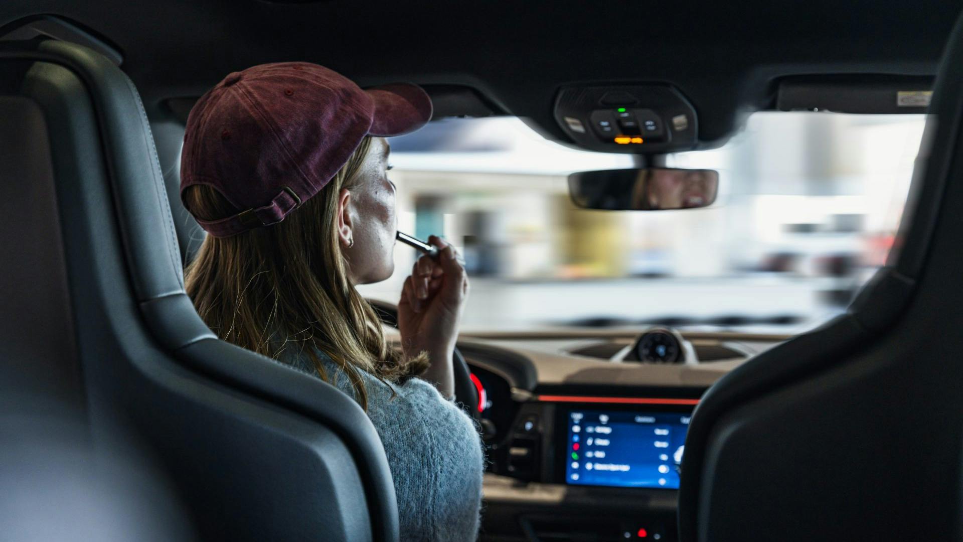 Woman demonstrating distracted driving