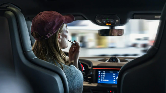 Woman demonstrating distracted driving