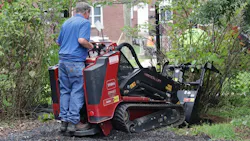 ARA Toro Community Impact Event in Baltimore. A man operates a Toro Dingo, cleaning up brush.
