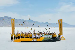 JCB Hydromax streamliner with crew, celebrating a land speed record.
