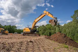 Case Construction Equipment CX220E excavator digging buckets of dirt.
