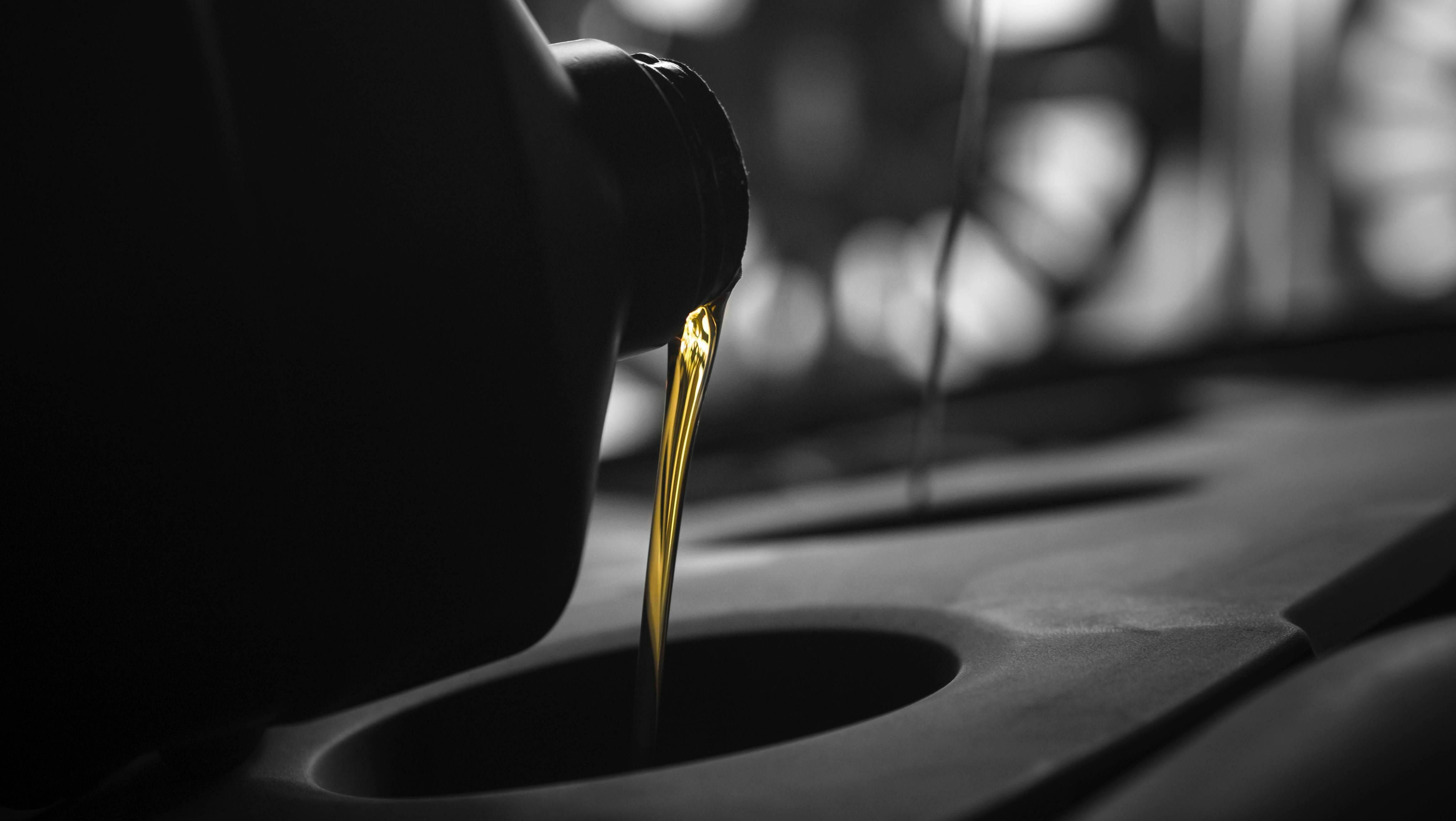 Motor oil pouring down a hole.
