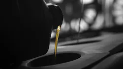 Motor oil pouring down a hole.