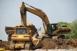 Construction Caterpillar Equipment - Construction workers digging in the dirt using CAT equipment.