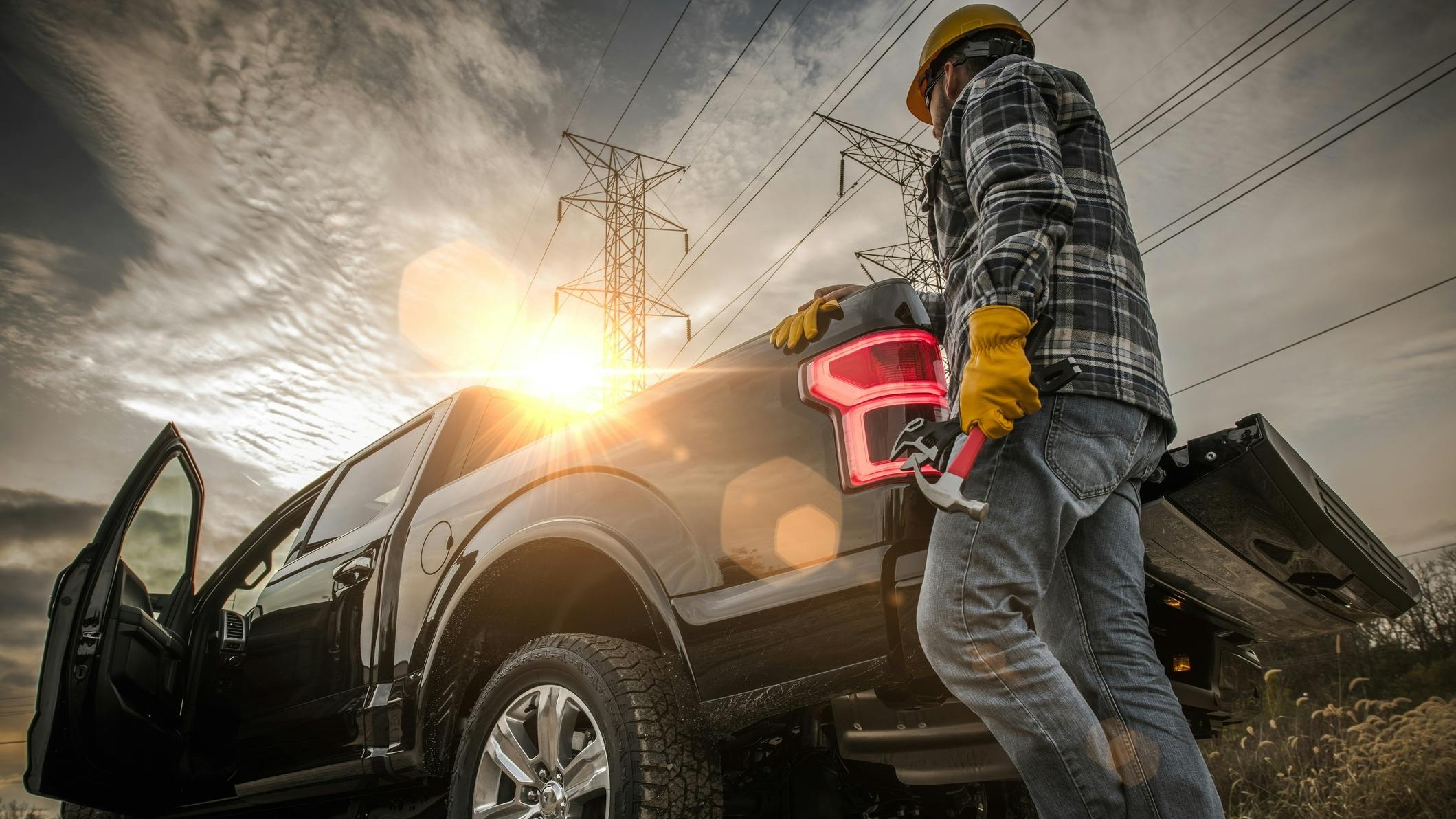 Contractor Field Research Future Construction Site. Field Work. Caucasian Worker and His Company Pickup Truck