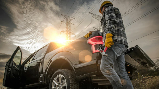 Contractor Field Research Future Construction Site. Field Work. Caucasian Worker and His Company Pickup Truck