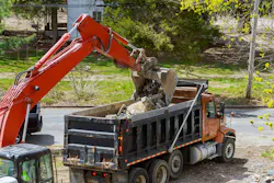 Truck with excavator loading for removal of debris construction waste building demolition. Truck with excavator loading for removal of waste building demolition debris construction
