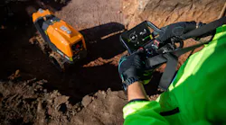 Ammann remote-control trench roller. Operator controls it from above with a remote.