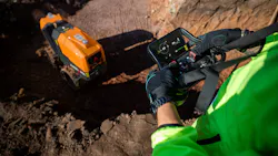 Ammann remote-control trench roller. Operator controls it from above with a remote.