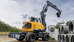 Hyundai HW100A wheeled excavator lifting pipes and culverts.