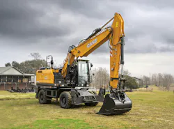 Case WX210E wheeled excavator sitting in the grass.