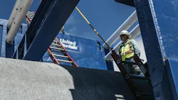 United Rentals Trench box with a worker nearby.