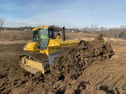Komatsu Dozer D71PXi pushing dirt up a hill.
