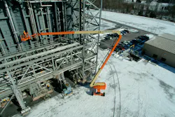 JLG 1250AJP boom lift working in the snow.