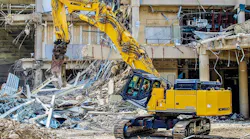 KOBELCO SK650DLC-11 demo excavator with metal shears, tearing apart a building.