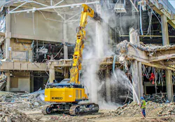 KOBELCO SK650DLC-11 demo excavator with metal shears, tearing apart a building.