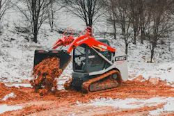 Takeuchi compact track loader working in the red mud.