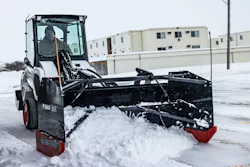 Bobcat L28 wheel loader with a Snowpusher Pro attachment, removing snow.