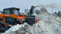DEVELON DTL35 compact track loader using a snowblower for snow removal.