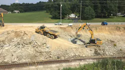 An excavator and haul truck at work