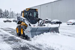 Hilltip’s SnowStriker SFT Flex attachment moving snow.