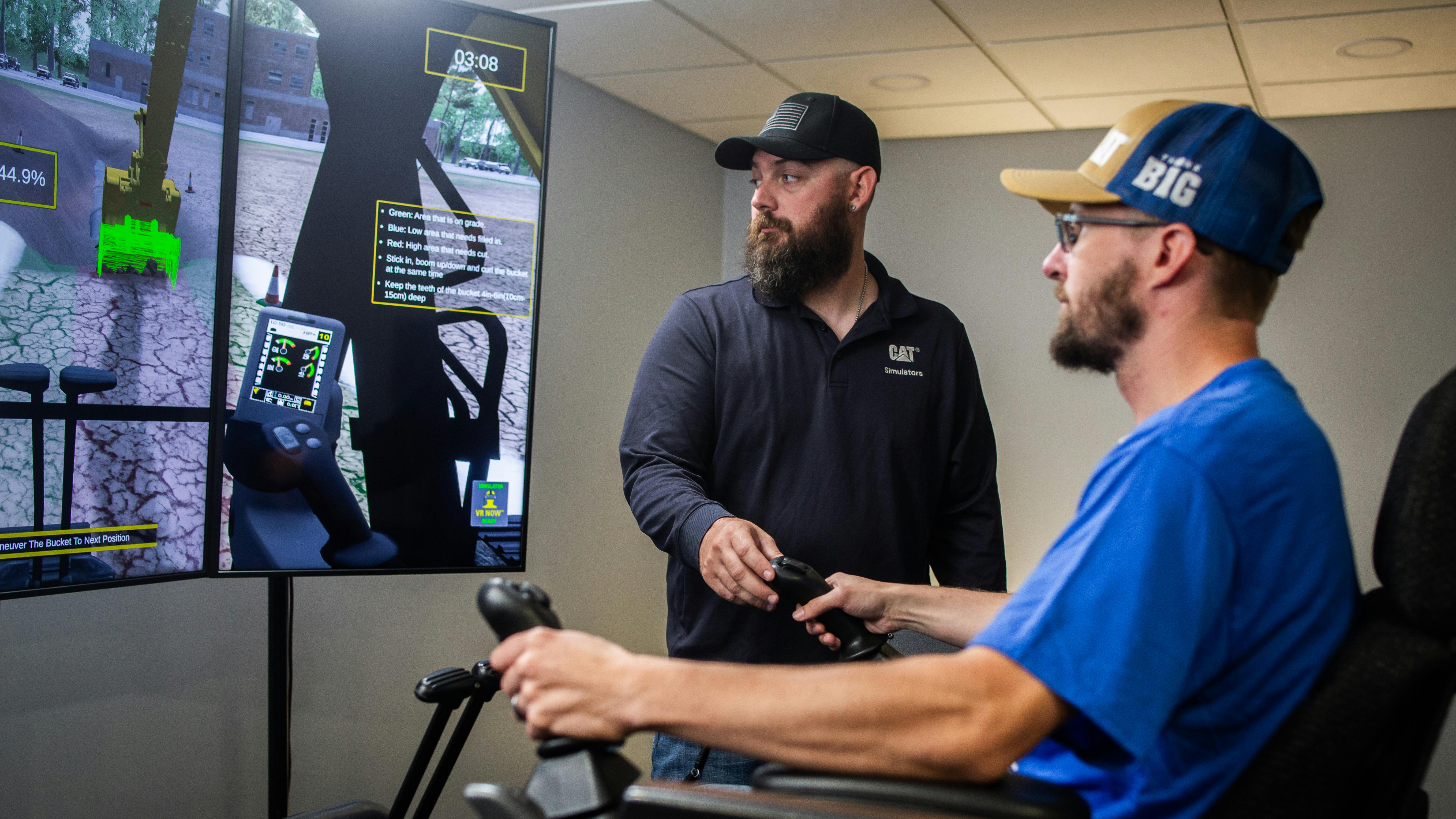 Caterpillar Next Gen Excavator Utilities Package. Man directs an operator on a simulator.