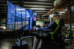 A man operators a Cat compact track loader simulator module.