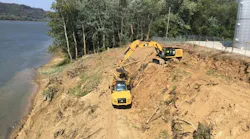 Excavator and ADT on a slope next to water
